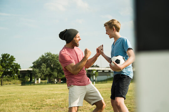 Germany, Mannheim, Father and son playing soccer