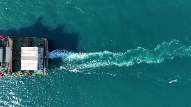 cargo container ship fully loaded with pink and red containers, assisted by a tugboat in the turquoise ocean. Global maritime logistics and supply chain concept.	international trade, and heavy ship
