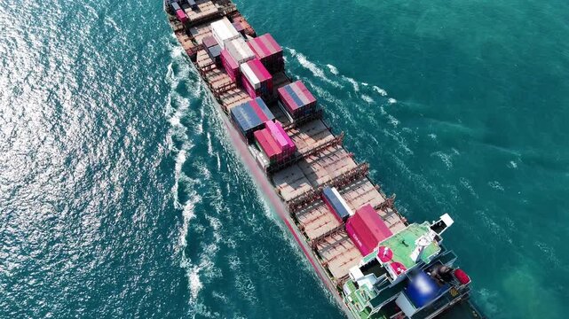 cargo container ship fully loaded with pink and red containers, assisted by a tugboat in the turquoise ocean. Global maritime logistics and supply chain concept.	international trade, and heavy ship