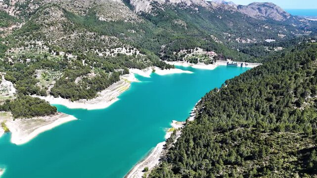 Scenic mountain lake surrounded by forest in Spain, perfect for travel and nature enthusiasts.