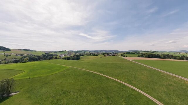 Sunny drone flight above Lembach im M&uuml;hlkreis in the M&uuml;hlviertel region of Upper Austria. Green hills, forests and countryside create a peaceful rural landscape.