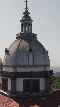 Vertical aerial close-up orbital shot of the church dome at Sanctuary of Our Lady of Sameiro in Braga, Portugal.