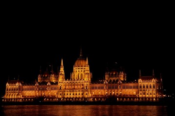 Fototapeta premium Illuminated historic riverside building at night in Budapest Hungary