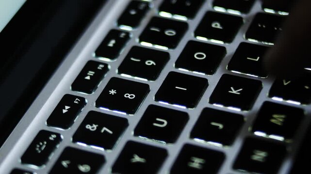 close up typing on a laptop keyboard