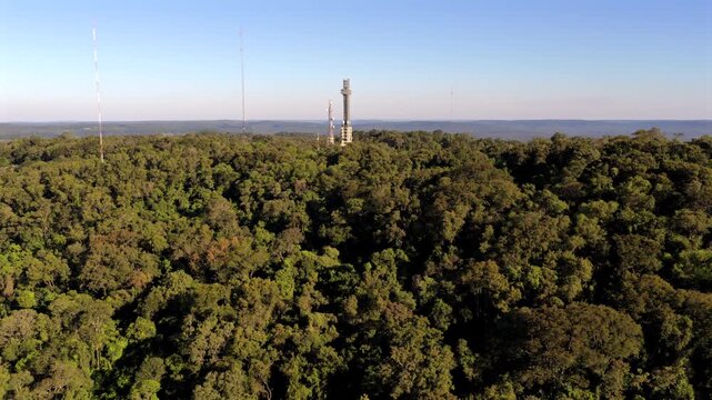 The Cross Monument towers over dense forest in Parque Tem&aacute;tico de la Cruz, Santa Ana. Ideal for travel documentaries or cultural features.