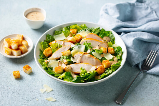 Healthy Caesar Salad with croutons, creamy dressing, fresh romaine lettuce, shaved parmesan. Close up