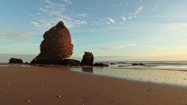 Stunning golden hour footage of the historic Torre del Loro ruins on the beach. Great for history documentaries, travel marketing, cultural heritage, and coastal relaxation.