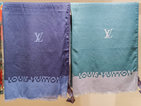 Two luxury Louis Vuitton scarves hanging on display. London, UK, 8 June 2024