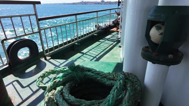Green marine rope coil on a ferry boat deck sailing on the sea in Istanbul Bosphorus, Turkey