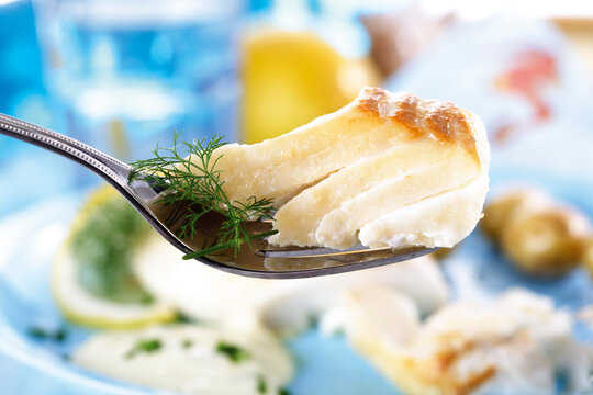 Codfish with dill on fork