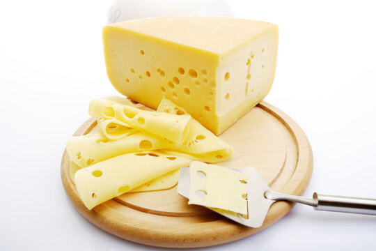 Sliced cheese on chopping board