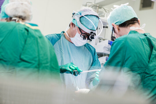 Heart surgeons and operating room nurse during an operation