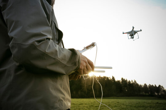 Man on a meadow flying drone