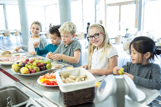 Students lining up to order food at the school cafeteria counter