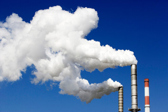 Smoke emitting from chimney stack, low angle view
