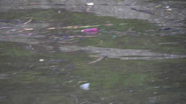Flood Water Running with Force Carrying Plastic Waste and Garbage in Polluted River Environmental Crisis in Bhaktapur, Nepal.