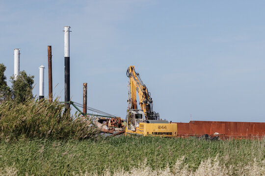 Liebherr excavator working on river bank construction site