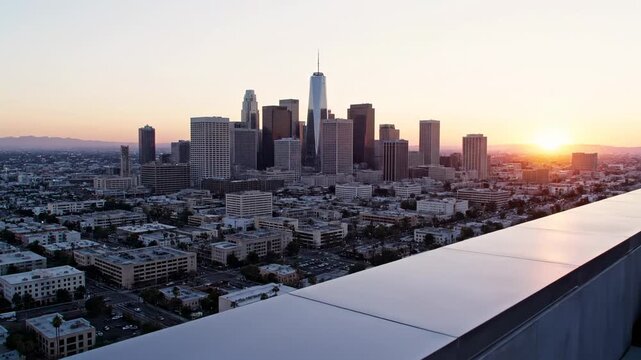 Expansive urban panorama capturing the majestic metropolitan skyline graced by the gentle glow of sunrise, offering a commanding high-angle perspective of architectural grandeur and sprawling