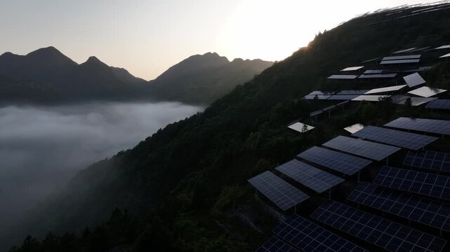 Sunrise over misty mountain terraced fields with clouds and green slopes