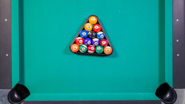 Top View of Billiard Balls Racked in a Triangle on Green Felt Table