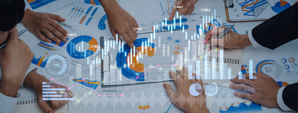 Business professionals collaborate in a meeting, analyzing financial data and graphs on a table, enhanced by digital graphic overlays for visual impact. Scalp