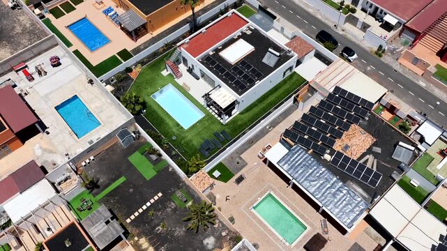 Aerial view of luxury expatriate villas with private swimming pools and real estate development in Caleta de Fuste