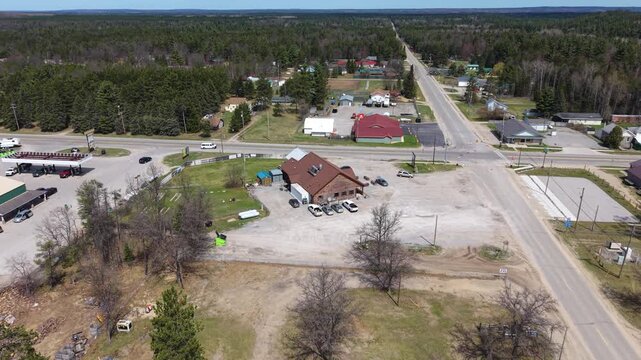 Drone orbiting shot around center of small town Luzerne Michigan.