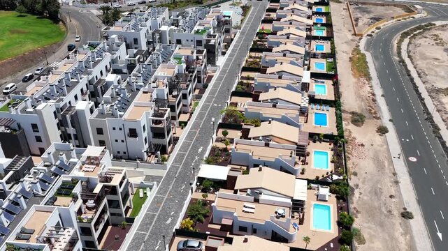 Aerial view of luxury expatriate villas with private swimming pools and real estate development in Caleta de Fuste