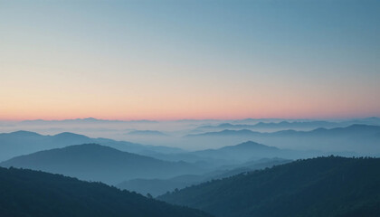 Obraz premium Serene mountain landscape at sunrise with misty valleys and rolling hills under a gradient sky
