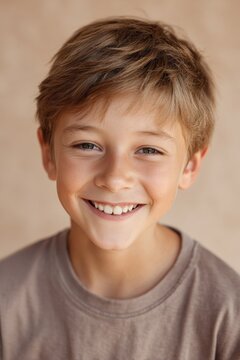 Close-up headshot of a cheerful boy with a bright toothy smile