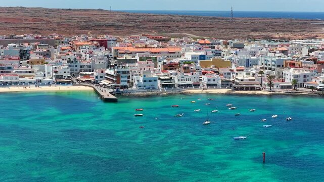 Aerial view of Corralejo beach promenade coastal resort town and active water sports in Fuerteventura