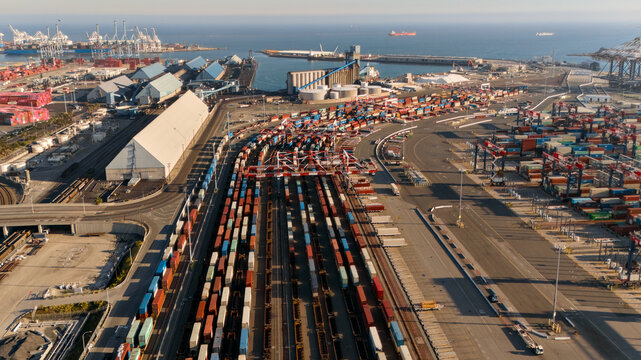 Drone view of shipping containers rail yard and industrial harbor