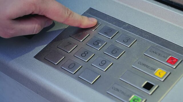 Close-up of hand entering PIN code at ATM, concept of banking security and transactions. High quality 4k footage