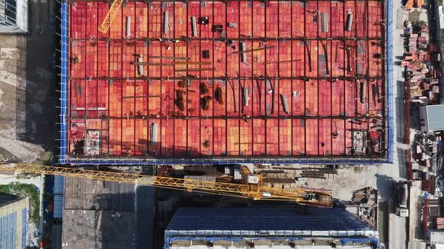 Aerial view of construction site with red formwork and steel reinforcement structure