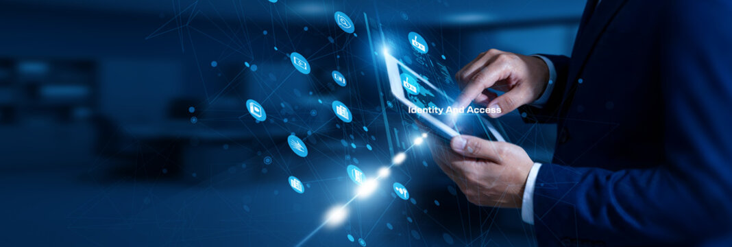 IAM Specialist touching identity and access using tablet secure network, authentication, authorization, user control, security.