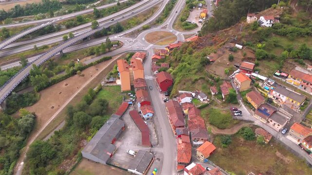 Drone aerial view of mountain houses and green valley near La Pena Asturias