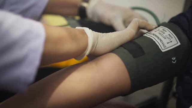 Close-Up of Blood Pressure Check on Patient Hand