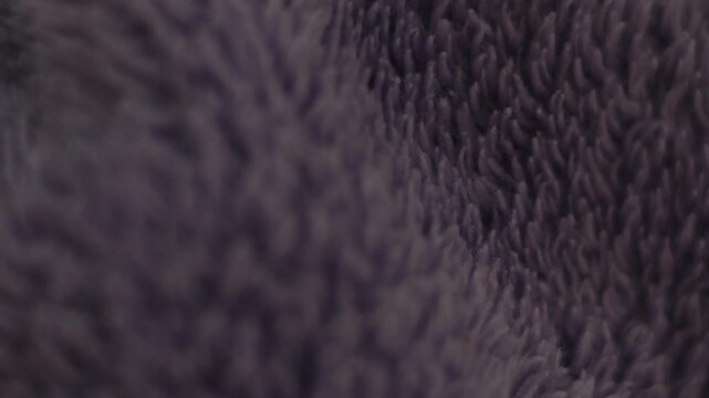 Close-up soft purple towel fabric texture with shallow depth of field