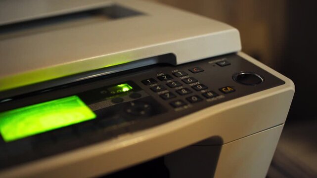 Close-Up of Hand Pressing Photocopy Machine Button