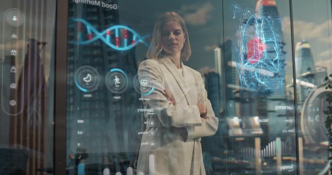 Woman Stands at a Smart Glass Window Overlooking City, with Gesture activated Holographic Health Care, Wellness Metrics Software App, Visualizing Predictive Health Tech. Medium Static Shot.