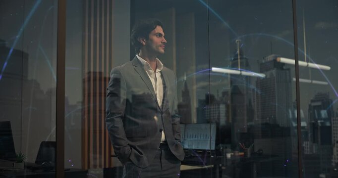Businessman Inside Modern Office Looks at Night City Through Window Reflecting Glowing Blue Network Arcs Representing Interconnected Digitalization and Global Information Flow.