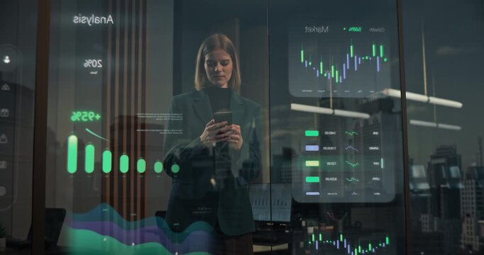 Female Executive Stands by Window Inside Modern Office Using Smartphone. Visualisation of Application Showing Augmented Stock Market Candlestick Graphs, Trading Performance Metrics, Fintech Analytics
