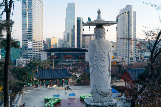 Seoul cityscape with a large Buddha statue in the foreground. South Korea