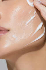 Fototapeta premium Hydrating Face Cream Application on Healthy Glowing Skin, Premium Skincare Beauty Treatment