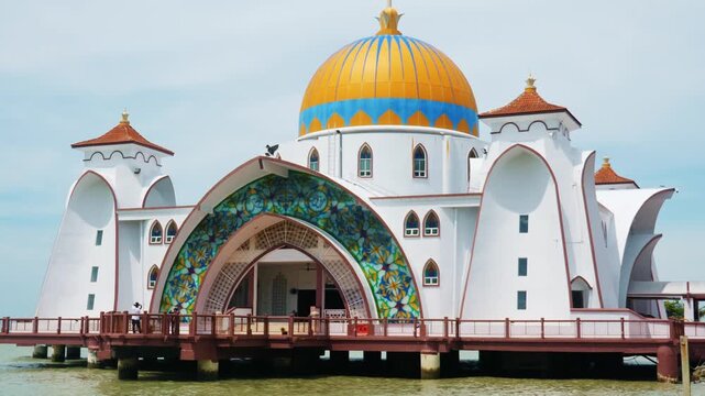 Malacca Straits Mosque, Masjid Selat Melaka, built on stilts over sea water, Islamic architecture with gold dome and stained glass, travel destination in Malaysia, documentary .