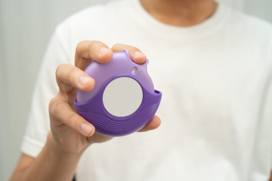 Asthma and chronic obstructive pulmonary disease COPD, Asian teenage using metered dose inhaler MDI.