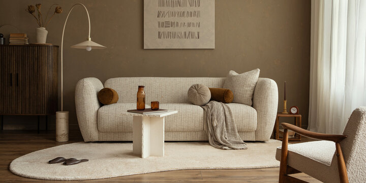 Minimalist living room interior showcasing a curved sofa, unique coffee table, abstract art, and warm, inviting tones