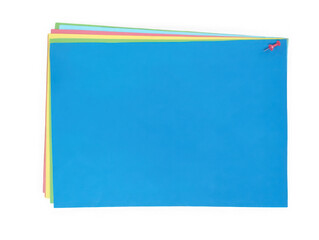 Fototapeta premium Stack of colorful paper sheets with a red push pin isolated on white background
