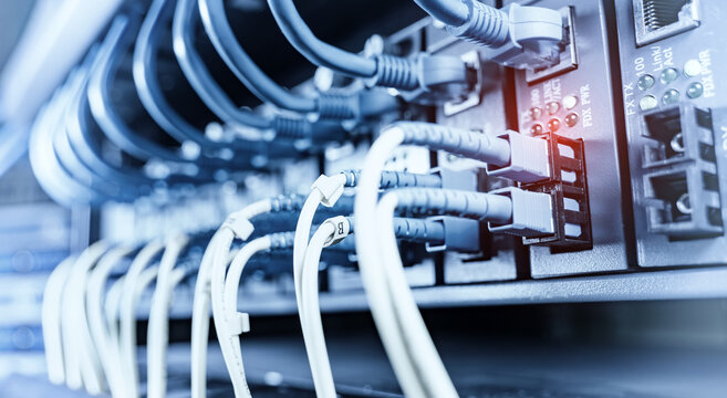 High-Speed Fiber Optic Cables Connected to Network Ports in Data Center Server Rack, IT Infrastructure and Cloud Computing Concept.