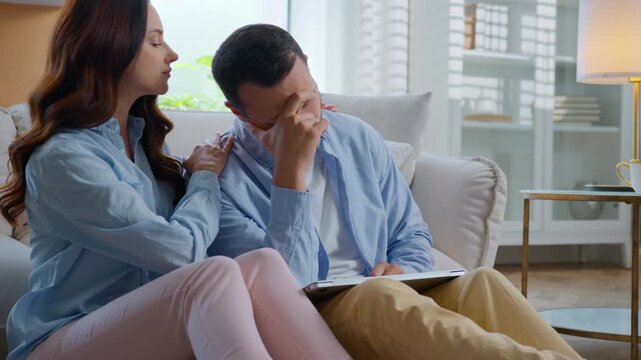 Caucasian man sad with laptop failure feeling stress woman supporting calming helping at home couple family relationship. Frustrated stressed male losing money with computer bet female support hugging